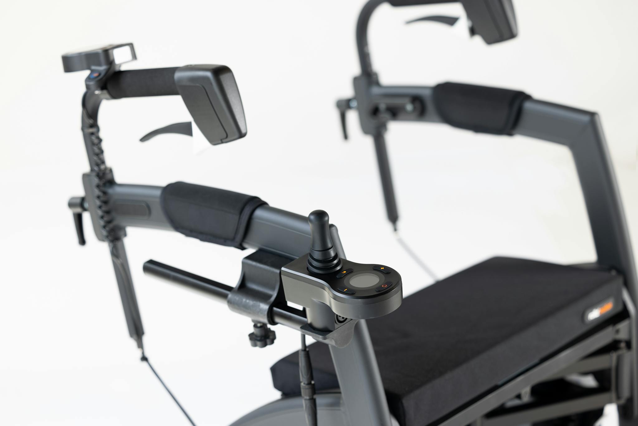 Close-up of a mobility aid showcasing a joystick controller on a sleek black frame.
