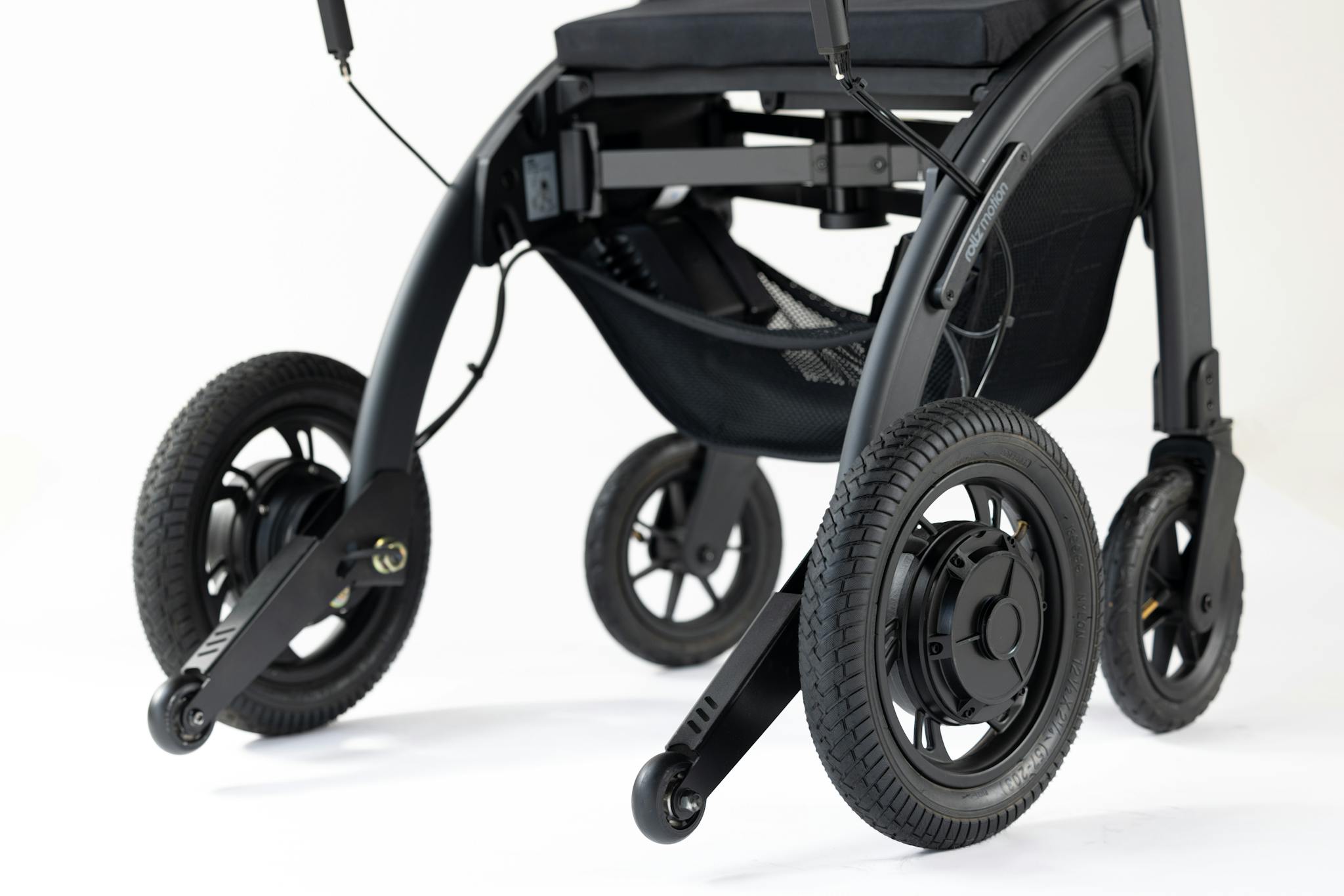 Close-up of a modern wheelchair featuring sleek black wheels on a white background.
